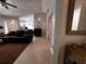 This living room has an open floor plan, a ceiling fan, and light wood-look tile floors at 10207 Cody Ln, Orlando, FL 32825