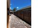 Paver walkway on the side of the house features wood fencing for extra privacy at 10207 Cody Ln, Orlando, FL 32825
