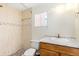 Well-lit bathroom with a single sink vanity and a shower featuring light tile at 1101 Oregon Ave, St Cloud, FL 34769