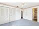 Spacious bedroom with multiple closets, ceiling fan, and access to bathroom at 1101 Oregon Ave, St Cloud, FL 34769