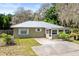 Charming single-story home with a metal roof, screened porch, and well-maintained landscaping at 1101 Oregon Ave, St Cloud, FL 34769