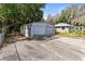 Detached two-car garage with a spacious driveway, complemented by the main house in the background at 1101 Oregon Ave, St Cloud, FL 34769