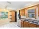 Functional kitchen featuring stainless steel appliances, wood cabinets, ample counter space, and tiled flooring at 1101 Oregon Ave, St Cloud, FL 34769