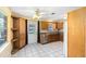 Well-lit kitchen featuring tiled floors, wood cabinetry, stainless steel appliances, and a backyard door at 1101 Oregon Ave, St Cloud, FL 34769