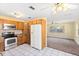 Open kitchen area with tiled floors, white appliances, and connecting views to the living room, creating a spacious layout at 1101 Oregon Ave, St Cloud, FL 34769