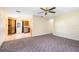 Open living space connecting to the kitchen area, featuring neutral walls, carpet, and an airy layout at 1101 Oregon Ave, St Cloud, FL 34769