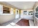 View of the covered porch with open windows that allow lots of light at 1101 Oregon Ave, St Cloud, FL 34769
