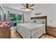 Comfortable bedroom with a large bed, hardwood floors, and access to a private balcony at 1129 Park Ridge Cir, Kissimmee, FL 34746