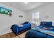 Bright bedroom featuring two twin beds, a TV, and cheerful decor at 1129 Park Ridge Cir, Kissimmee, FL 34746