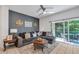 Cozy living room with a comfortable sofa, stylish decor, and sliding doors to the patio at 1129 Park Ridge Cir, Kissimmee, FL 34746