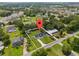 Aerial view of a property in a suburban neighborhood with mature trees and well-kept lawns at 1158 Stroupe Rd, Kissimmee, FL 34744