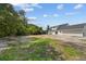 Spacious backyard featuring a well maintained grass lawn and view of the rear exterior of the home at 1158 Stroupe Rd, Kissimmee, FL 34744