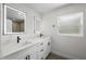Stylish bathroom featuring double vanity, granite countertop, and LED mirrors with black fixtures at 1158 Stroupe Rd, Kissimmee, FL 34744