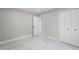 Bedroom with marble flooring, gray walls and view of the door and closet at 1158 Stroupe Rd, Kissimmee, FL 34744