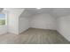Bright bedroom featuring light gray flooring, white walls and trim, and a window offering natural light at 1158 Stroupe Rd, Kissimmee, FL 34744