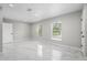 Well lit bedroom with marble floors and two windows at 1158 Stroupe Rd, Kissimmee, FL 34744