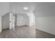Bright bedroom featuring light gray flooring, white walls and trim, with doors to other rooms at 1158 Stroupe Rd, Kissimmee, FL 34744