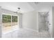 Open dining area with decorative light fixture and sliding glass doors to yard at 1158 Stroupe Rd, Kissimmee, FL 34744