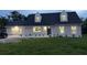 Charming home with a well-maintained lawn, inviting entrance, and modern exterior lighting at 1158 Stroupe Rd, Kissimmee, FL 34744
