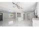 Open floorplan, featuring a center island, modern lighting and marble flooring at 1158 Stroupe Rd, Kissimmee, FL 34744