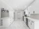 Modern kitchen with white cabinets, stainless steel appliances, and marble floors at 1158 Stroupe Rd, Kissimmee, FL 34744