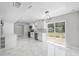 Spacious kitchen with modern white cabinetry, sleek appliances, and marble tile flooring at 1158 Stroupe Rd, Kissimmee, FL 34744