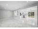 Open concept view of the living space with marble floors leading to the kitchen and outdoor access at 1158 Stroupe Rd, Kissimmee, FL 34744