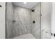 Modern walk-in shower with gray tile, sleek fixtures, and bright lighting at 1158 Stroupe Rd, Kissimmee, FL 34744