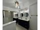 Bathroom featuring double sinks, modern lighting fixtures, and decorative wallpaper at 1211 Lehigh St, Kissimmee, FL 34744