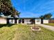 Charming single-story home with well-maintained lawn, crisp white paint and modern black trim at 1211 Lehigh St, Kissimmee, FL 34744