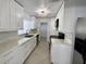 Modern white kitchen boasting marble countertops, updated cabinets, and stainless steel appliances at 1211 Lehigh St, Kissimmee, FL 34744