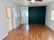 Bright living room featuring hardwood floors and an accent wall in a renovated home at 1211 Lehigh St, Kissimmee, FL 34744