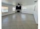 Spacious living room featuring neutral tile flooring, bright windows, and a fireplace with a decorative mantle at 1211 Lehigh St, Kissimmee, FL 34744