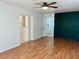Living area with hardwood flooring, an accent wall and an open doorway to an adjacent room at 1211 Lehigh St, Kissimmee, FL 34744