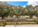 Paver patio backyard overlooks the lush golf course with seating area and well-maintained landscaping at 1225 Radiant St, Reunion, FL 34747