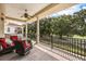 Covered balcony with ceiling fan, golf course views, and wrought iron railings provides a relaxing outdoor space at 1225 Radiant St, Reunion, FL 34747