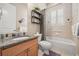 Functional bathroom featuring granite countertops, a large mirror, and shower-tub combination with stylish curtains at 1225 Radiant St, Reunion, FL 34747