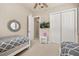 Neutral bedroom with twin beds, decorative mirror, ceiling fan, and television for entertainment at 1225 Radiant St, Reunion, FL 34747
