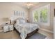 A cozy bedroom offers natural light with a large window and comfortable furnishings at 1225 Radiant St, Reunion, FL 34747