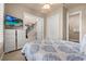 A cozy bedroom features a large window and a view of the staircase at 1225 Radiant St, Reunion, FL 34747