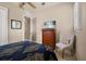 Comfortable bedroom with a dresser, television, ceiling fan, chair, and soft neutral carpet at 1225 Radiant St, Reunion, FL 34747