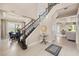 Elegant foyer with a staircase, tile flooring, and views into the dining room and living spaces at 1225 Radiant St, Reunion, FL 34747