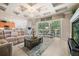 Cozy living room with a view of the pool and patio, featuring neutral tones and tile floors at 1225 Radiant St, Reunion, FL 34747