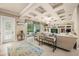 Beautiful living room with coffered ceilings, built-in shelving, tile floors, and access to the backyard at 1225 Radiant St, Reunion, FL 34747