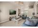 Upstairs living area with comfortable seating, TV, and adjacent reading nook with natural light at 1225 Radiant St, Reunion, FL 34747