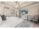 A spacious main bedroom features an ensuite bathroom, staircase access and TV at 1225 Radiant St, Reunion, FL 34747