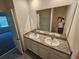 Bright bathroom features a double-sink vanity with granite countertops at 1370 Holodak Dr, Davenport, FL 33837