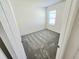 Neutral bedroom offers plush carpet and a large window for ample light at 1370 Holodak Dr, Davenport, FL 33837
