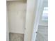 Storage closet features shelving and tile flooring adjacent to carpeted room at 1370 Holodak Dr, Davenport, FL 33837
