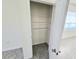 Linen closet includes shelves for organized storage; tiled floor visible at 1370 Holodak Dr, Davenport, FL 33837